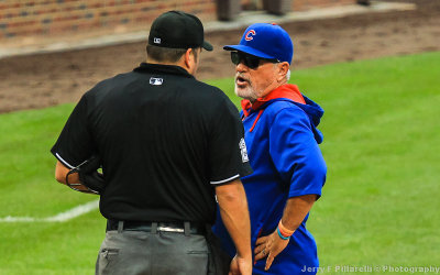 Chicago Manager Joe Maddon has a discussion with the umpire at Wrigley Field