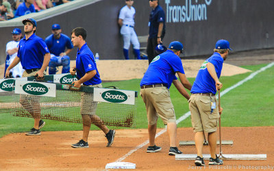 The Wrigley Field Grounds Crew rakes the infield during the 7th inning stretch