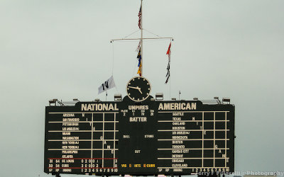 The W flag is hoisted above the scoreboard at Wrigley Field