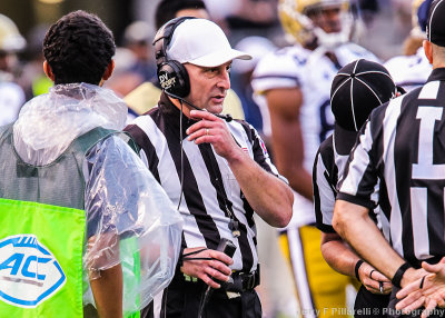 The head referee talks to the booth during a play review