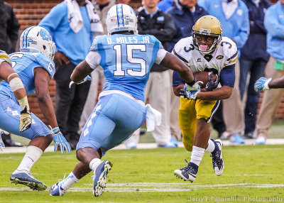 Tech A-Back Isiah Willis looks for a hole as Tar Heels defenders approach