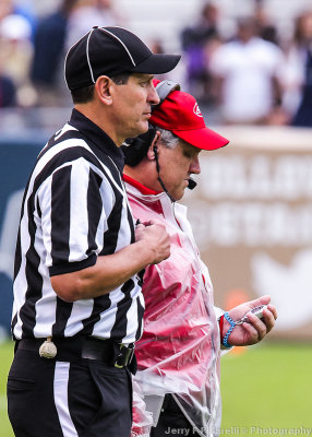 ACC official watches the commercial time on the field