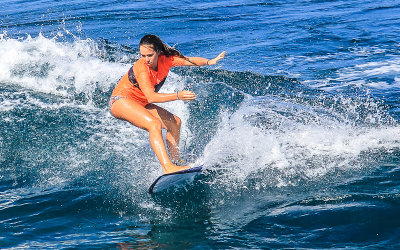 Surfer cutting through the water at Hookipa Beach along the Road to Hana