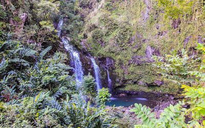 Water cascades into a pool along the Road to Hana
