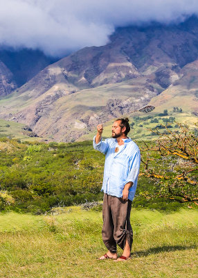 Man performs a spiritual ritual along the Piilani Highway