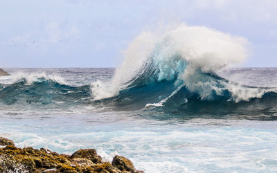 Wave breaks disrupting the clear blue waters in the National Park of American Samoa 