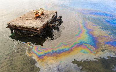 Oil surrounds the mooring bitts pad, for visiting vessels, of the USS Arizona in Pearl Harbor