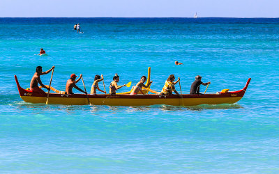 Tourists manning an Outrigger Canoe on Waikiki Beach