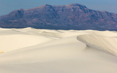 The Andres Mountains loom over the pure white gypsum sand dunes in White Sands National Monument