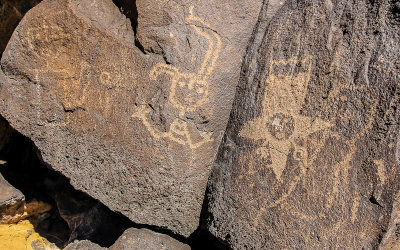 Human figures carved in the basalt in Boca Negra Canyon in Petroglyph National Monument