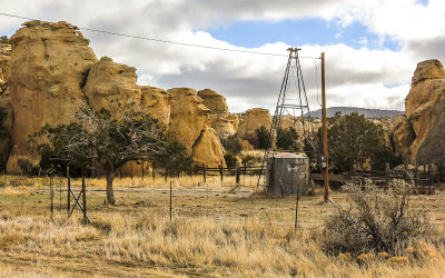Sandstone formations and an old ranch well along The Narrows in El Malpais National Monument