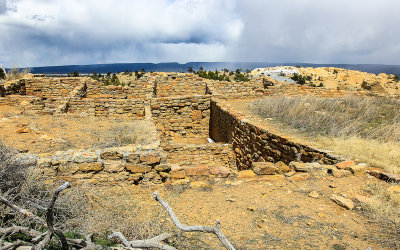 View of the pueblo with a snowstorm in the distance in El Morro National Monument