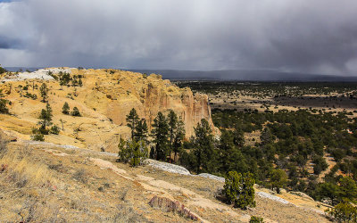 View of a snowstorm from on top of the El Morro Mesa in El Morro National Monument