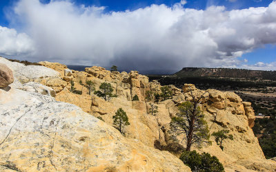 View from the top of the El Morro Mesa with a snowstorm in the distance in El Morro National Monument