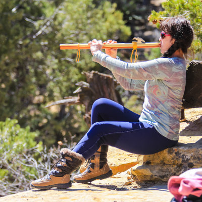 Woman plays an ancestral flute in Mesa Verde National Park