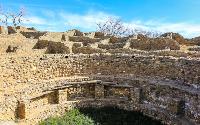 Kiva with the rest of the West Ruin in the background in Aztec Ruins National Monument