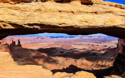 View of Washer Woman Arch, Airport Tower and Buck Canyon through Mesa Arch in Canyonlands National Park