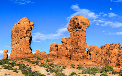 The moon over a rock formation in the Garden of Eden in Arches National Park 
