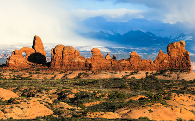 The Windows Section with snow falling on the La Sal Mountains in the background in Arches National Park