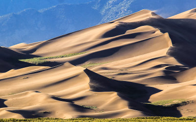 Wind blows the sand just before sunset in Great Sand Dunes National Park