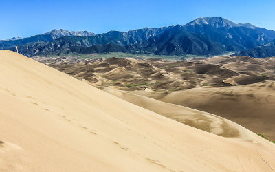 Lone visitor views the dune field from the peak of High Dune in Great Sand Dunes National Park