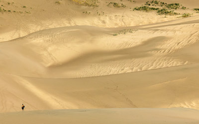A hiker on the dunes as seen from the Sand Pit Trail in Great Sand Dunes National Park