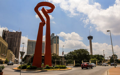 Art sculpture and the Tower of the Americas above the San Antonio River Walk