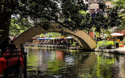 Restaurants and a bridge walkway along the San Antonio River Walk