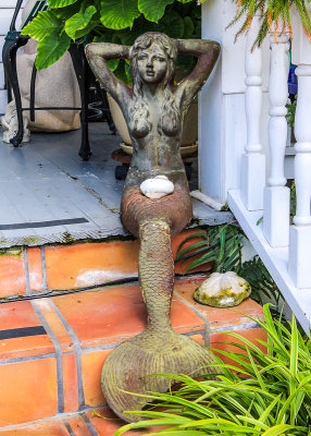 Mermaid statue on the front steps of a house in Key West