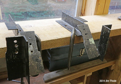 Pair of brackets clamped to a plank/work bench.