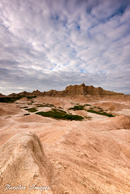 Clouds and light play over the badlands