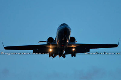 2013 - Lear Jet on short final approach after sunset corporate aviation stock photo