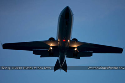2013 - Lear Jet on short final approach to Opa-locka after sunset corporate aviation stock photo