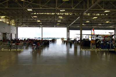2014 Coast Guard Day Picnic attendees dining on a variety of foods in the fixed-wing hangar at Air Station Miami