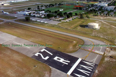 2011- climbing over the approach end of runway 27R at North Perry Airport aviation stock photo #7660