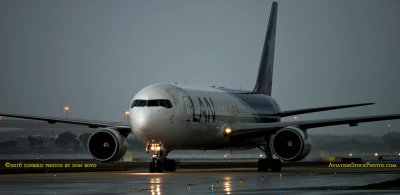 LAN Airlines B767-316ER CC-CXI taxiing in after landing on runway 27 before a storm aviation airline stock photo