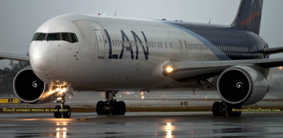 LAN Airlines B767-316ER CC-CXI taxiing in after landing on runway 27 before a storm aviation airline stock photo