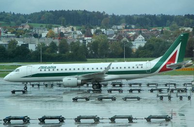 Alitalia E-90 in Zurich, with typical Swiss landscape as the background