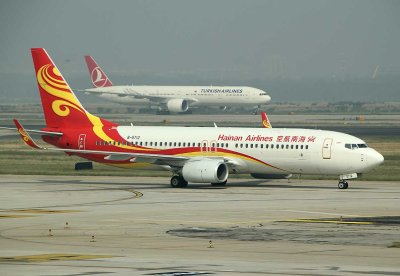 Hainan Airlines 737-800 taxi at PEK with a Turkish B-777-300 in the background