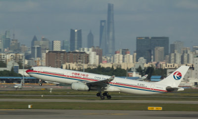 MU A-330 taking off with Shanghai skyline as the background, Nov 1 2016