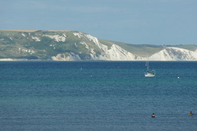 White cliffs of the Jurassic Coast, sailboat & swimmers, viewed from the ship