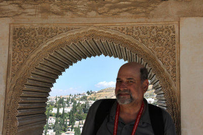Too hot to smile, Howard poses from Alhambra with Albaicin in background