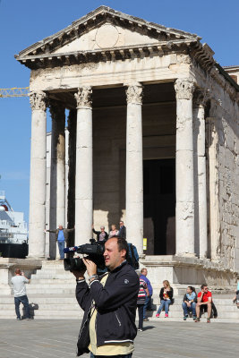 Few cruise ships visit Pula, so we were being filmed listening to the guide tell us about the Temple of Augustus.
