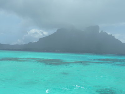 The water around where we dived (no Photoshop - real color!) & ominous weather back near Vaitape.  (Cleared up.)