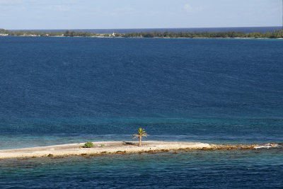In the middle of pass is tiny islet with one palm tree