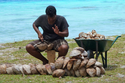 I passed a coconut seller hacking open coconuts  