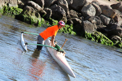 Chilean woman taking outrigger canoe out