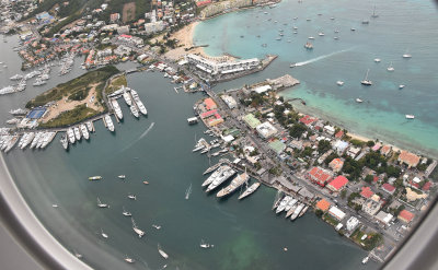 Airplane window view of the yachts when leaving St. Maarten