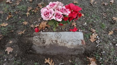 Chester's marker was half buried in the dirt. we cleaned it off and placed some flowers.  