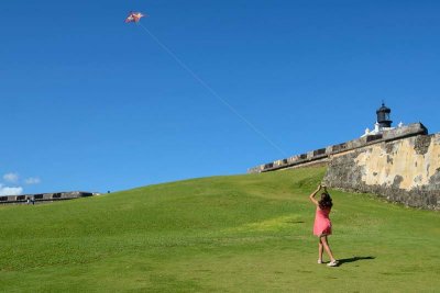 Girl in red, playing a kite